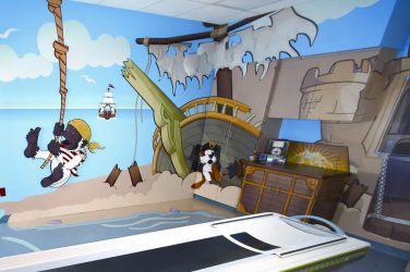 Reinvention and change to survive and thrive: Pirate-themed MRI room for children with cartoon illustrations on the walls, designed to create a comforting atmosphere.