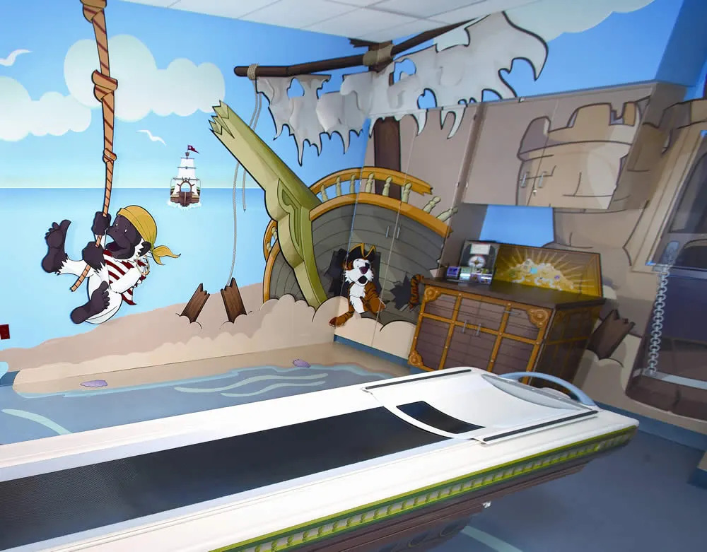 Reinvention and change to survive and thrive: Pirate-themed MRI room for children with cartoon illustrations on the walls, designed to create a comforting atmosphere.